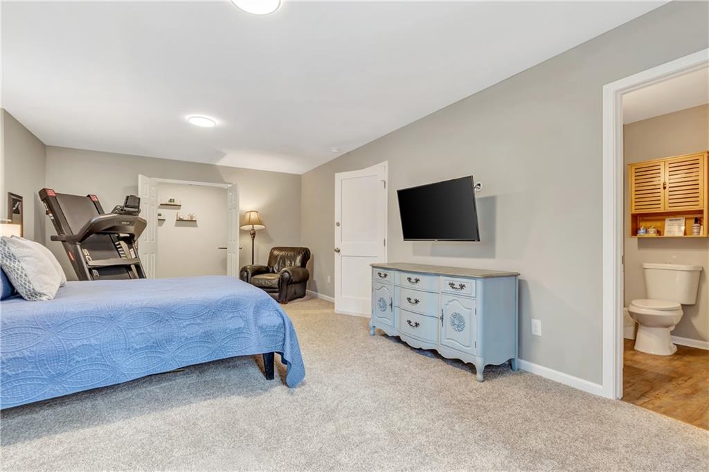 68 Skyview Road Senoia, GA 30276 - Photo 32 of 51 a bedroom with furniture a flat screen tv and a dresser