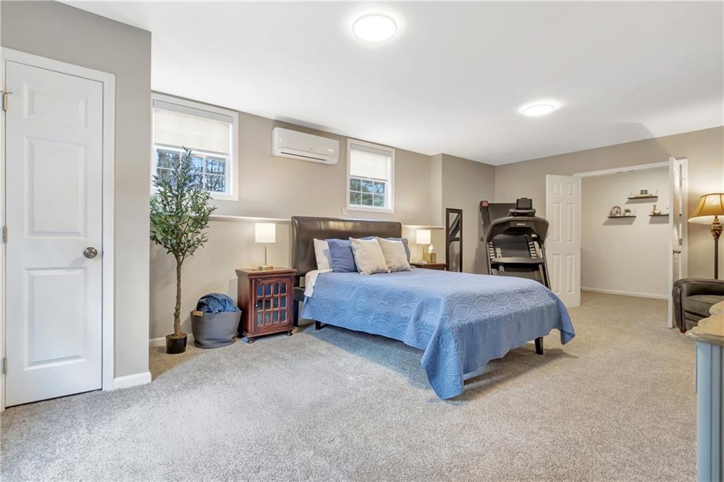 68 Skyview Road Senoia, GA 30276 - Photo 33 of 51 a spacious bedroom with a bed and a potted plant