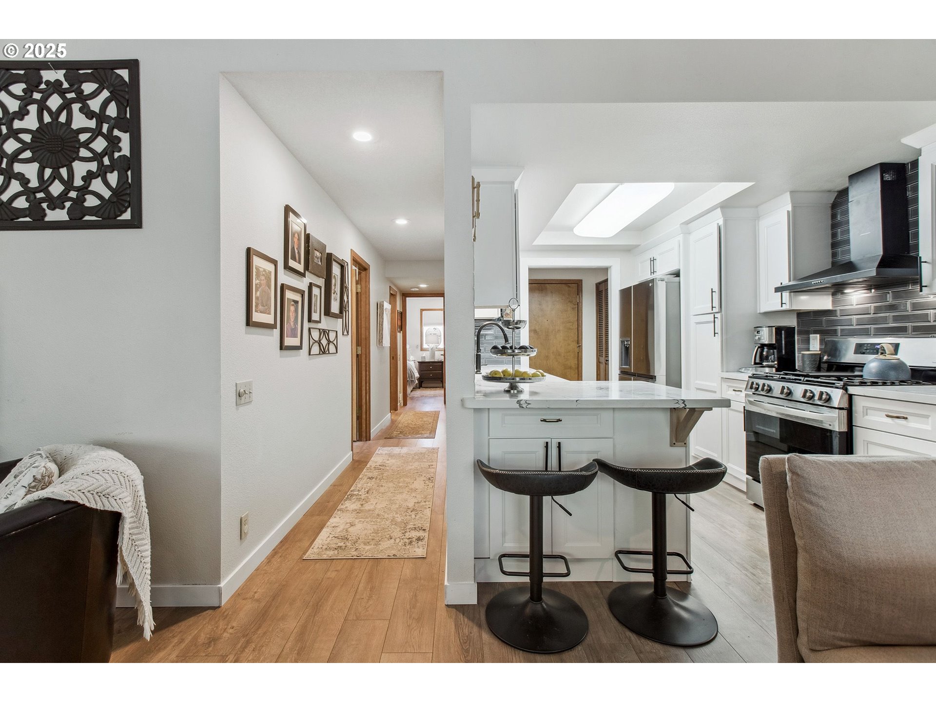 15565 Southwest 114th Court, Unit 26 Portland, OR 97224 - Photo 7 of 32 a view of living room kitchen with stainless steel appliances kitchen island granite countertop furniture and a view of kitchen