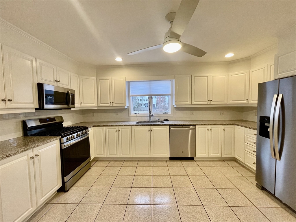 196 Linwood Avenue, Unit 196 Newton, MA 02460 - Photo 11 of 37 a kitchen with a sink a microwave and refrigerator