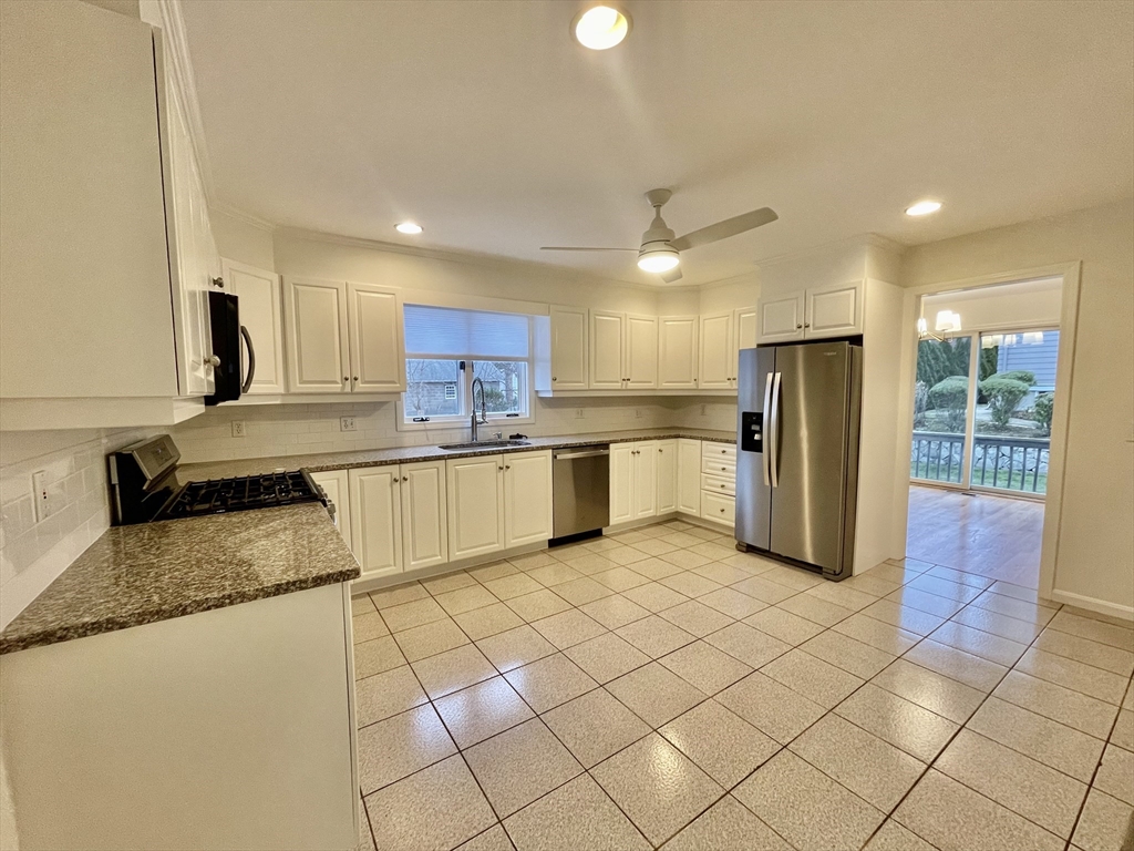 196 Linwood Avenue, Unit 196 Newton, MA 02460 - Photo 12 of 37 a kitchen with stainless steel appliances granite countertop a refrigerator sink and cabinets