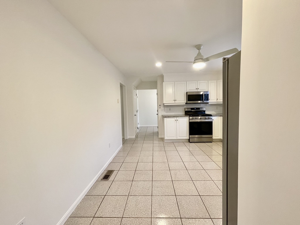 196 Linwood Avenue, Unit 196 Newton, MA 02460 - Photo 13 of 37 a kitchen with granite countertop a stove a sink and a refrigerator