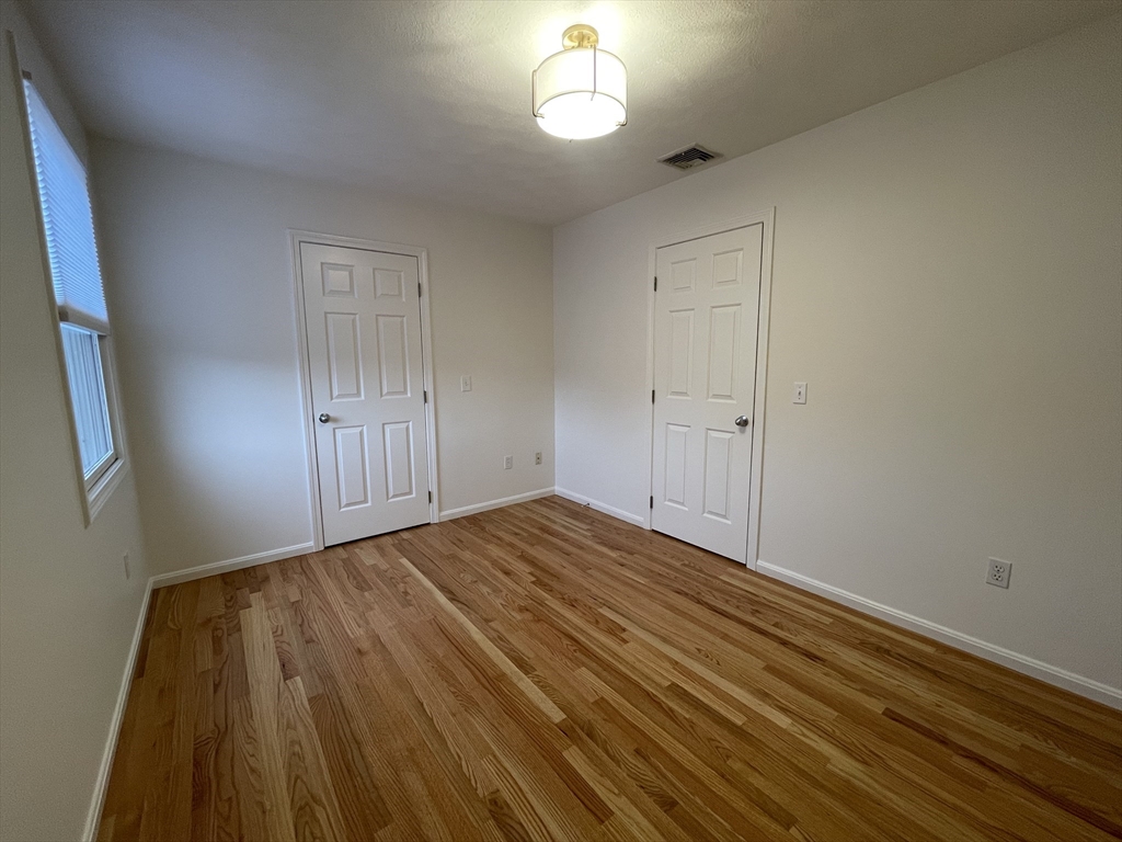 196 Linwood Avenue, Unit 196 Newton, MA 02460 - Photo 23 of 37 a view of empty room with wooden floor