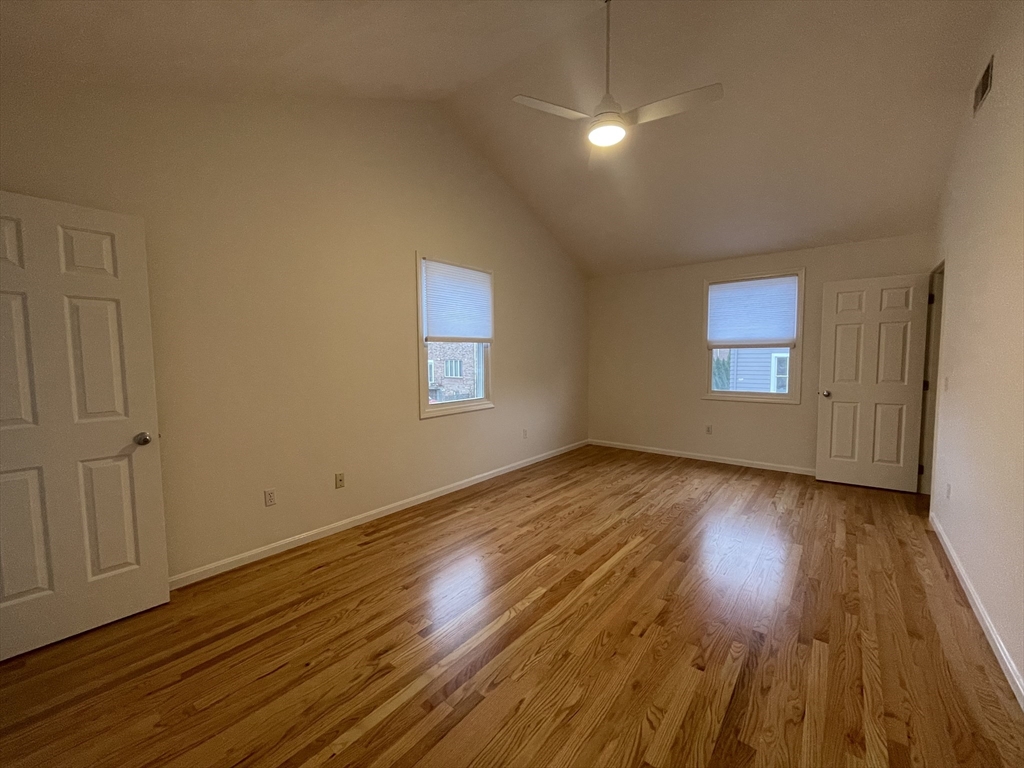 196 Linwood Avenue, Unit 196 Newton, MA 02460 - Photo 27 of 37 a view of empty room with wooden floor and fan