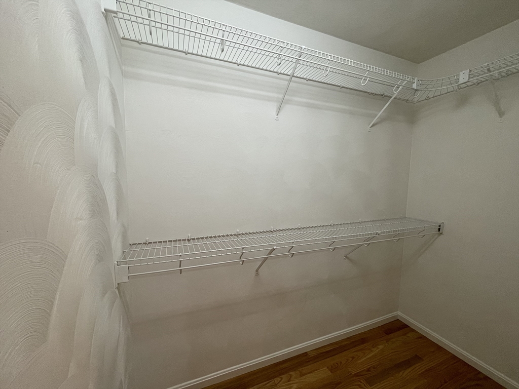 196 Linwood Avenue, Unit 196 Newton, MA 02460 - Photo 28 of 37 a view of a room with racks on the wall