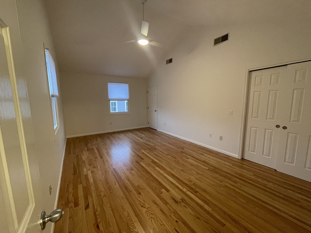 196 Linwood Avenue, Unit 196 Newton, MA 02460 - Photo 30 of 37 an empty room with wooden floor and windows