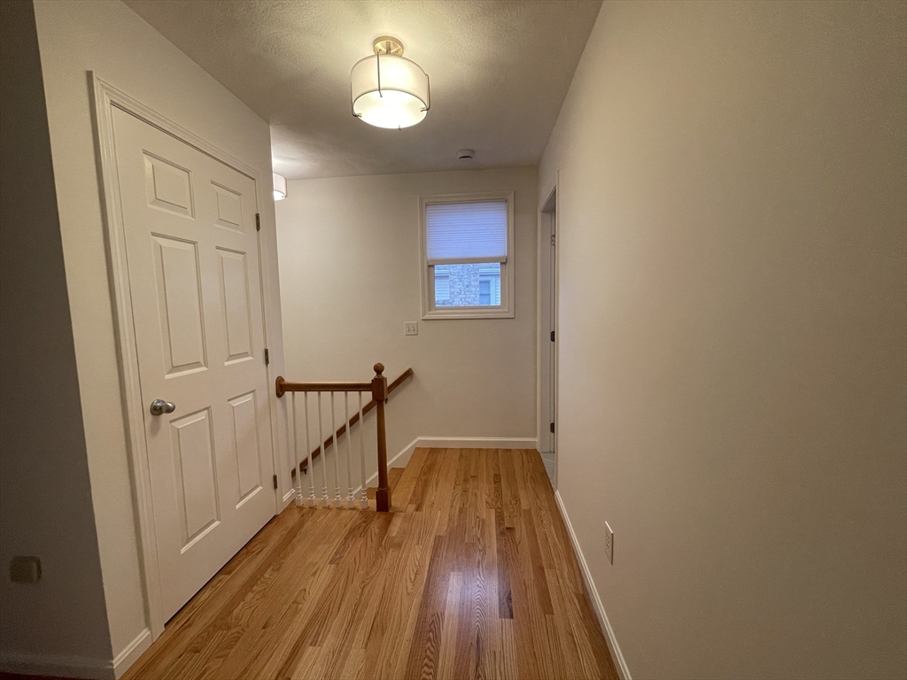 196 Linwood Avenue, Unit 196 Newton, MA 02460 - Photo 32 of 37 a view of a hallway with wooden floor