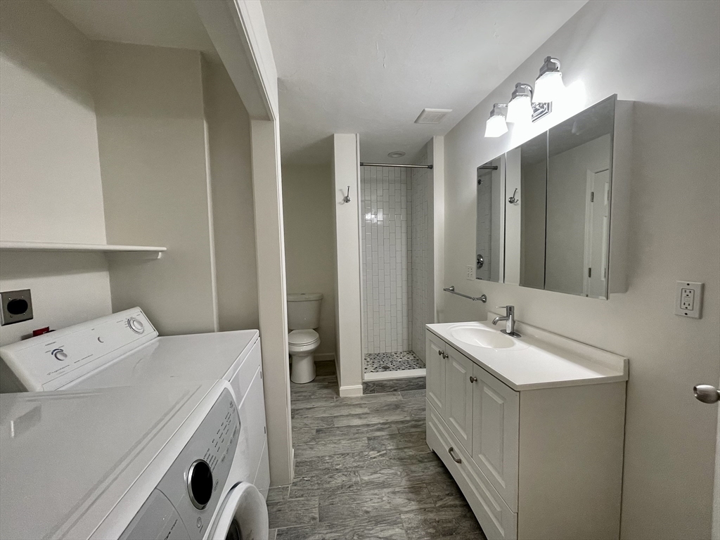 196 Linwood Avenue, Unit 196 Newton, MA 02460 - Photo 34 of 37 a bathroom with a double vanity sink and mirror
