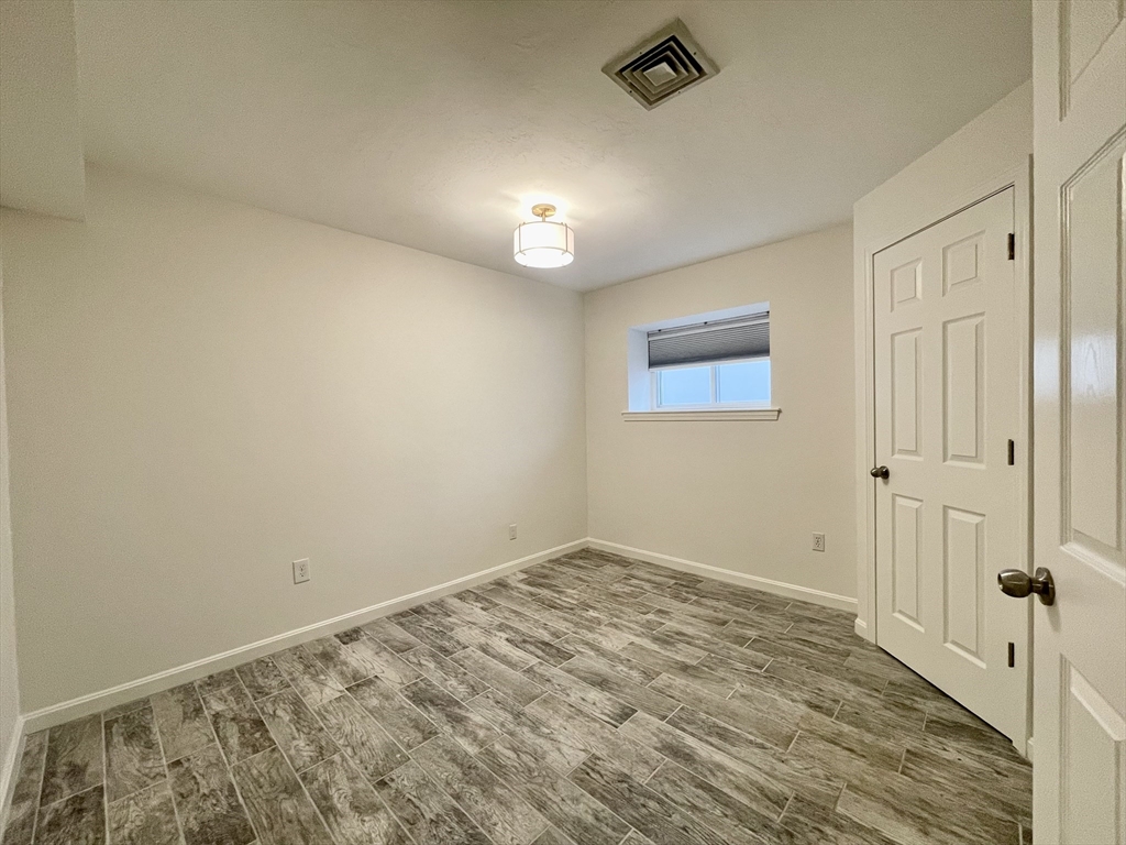 196 Linwood Avenue, Unit 196 Newton, MA 02460 - Photo 35 of 37 wooden floor in an empty room
