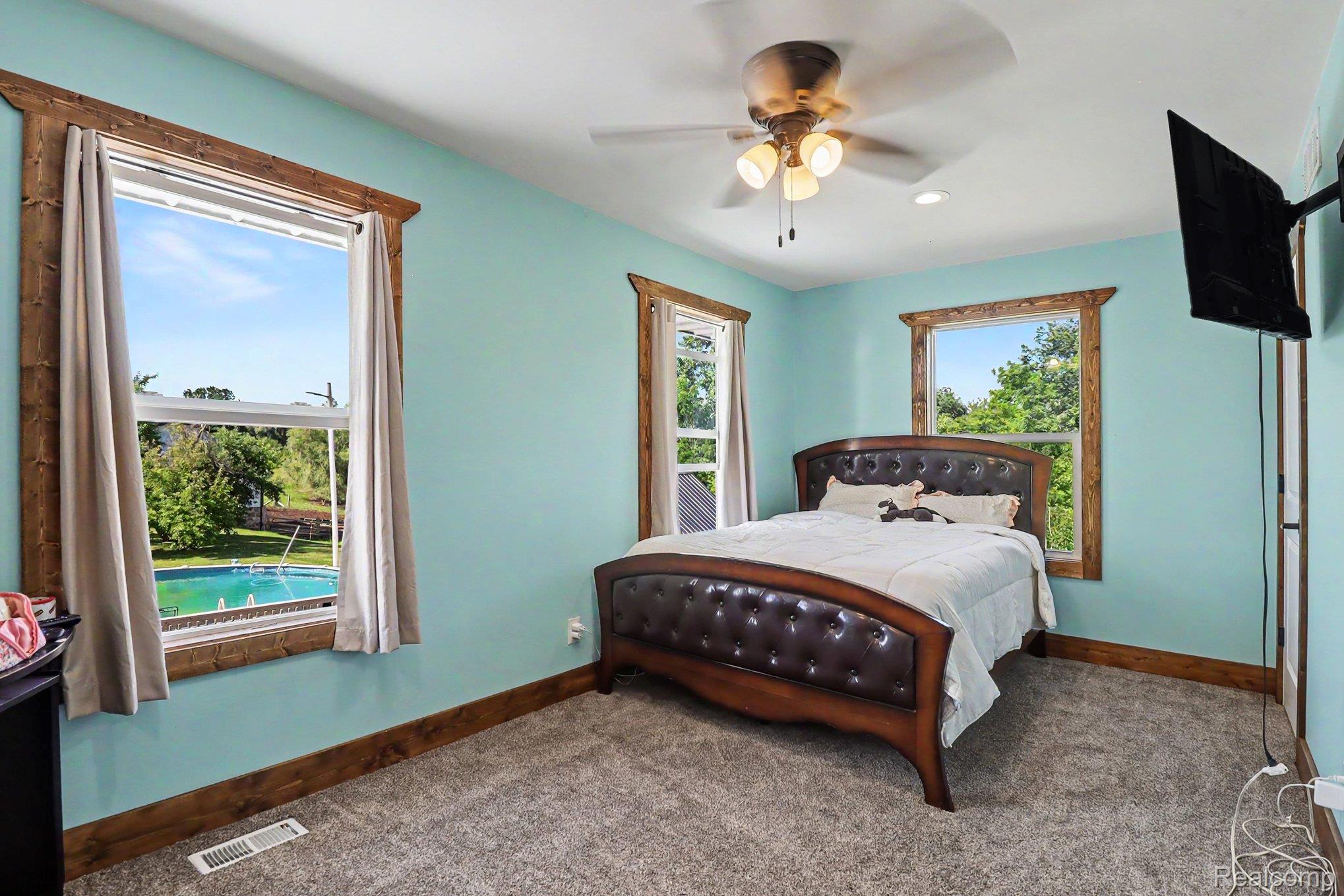 2150 East Snover Road Mayville, MI 48744 - Photo 26 of 48 Interior space featuring light blue walls and textured gray carpeting