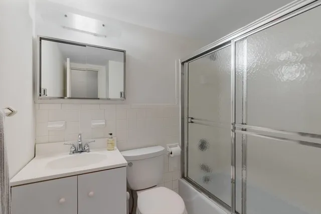 a bathroom with a toilet sink and shower