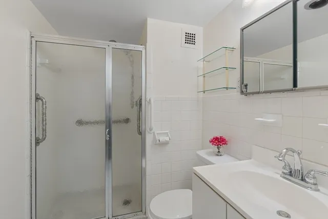 a bathroom with a sink toilet and shower