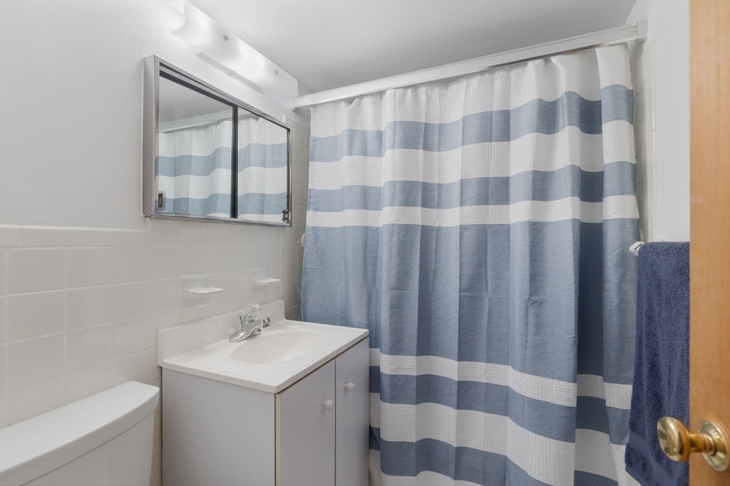 6 Whittier Place, Unit 14N&O Boston, MA 02114 - Photo 23 of 31 a bathroom with a sink and a mirror