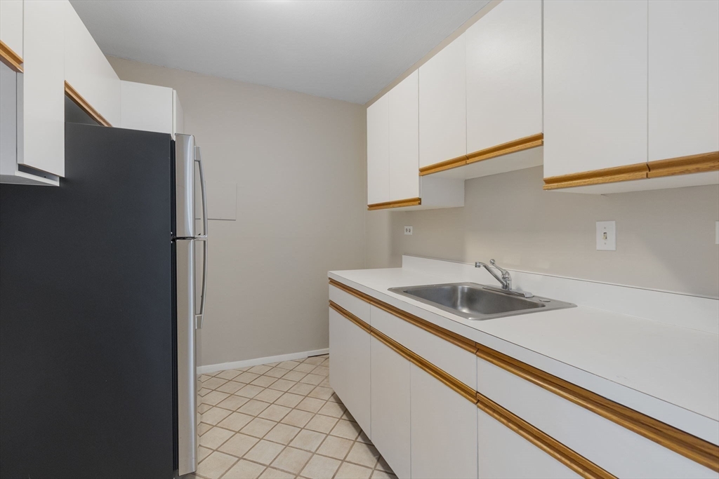 6 Whittier Place, Unit 14N&O Boston, MA 02114 - Photo 24 of 31 a kitchen with a sink and a refrigerator