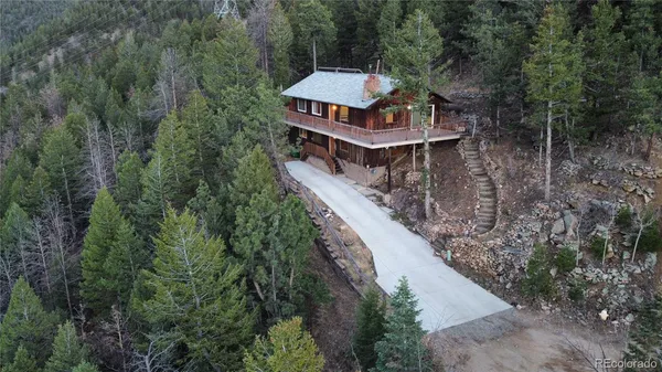 a view of a room with wooden floor and windows