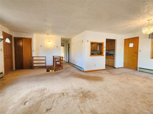 a store with outdoor seating area and blue umbrellas