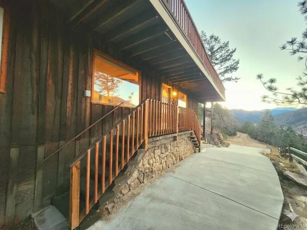 a view of balcony with wooden floor and fence