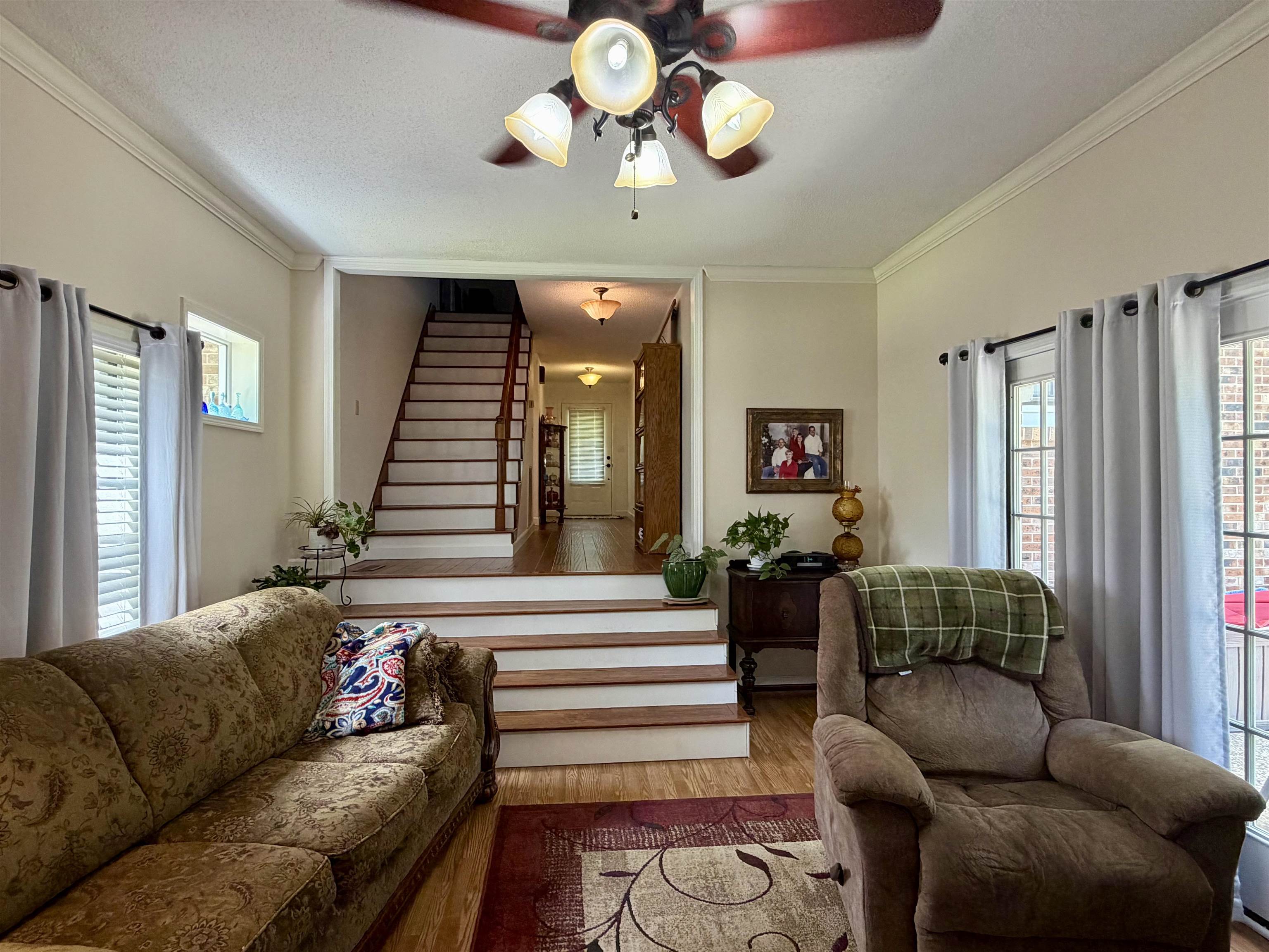 142 Treece Street Selmer, TN 38375 - Photo 4 of 36 Open living area featuring wood-finish flooring and crown molding