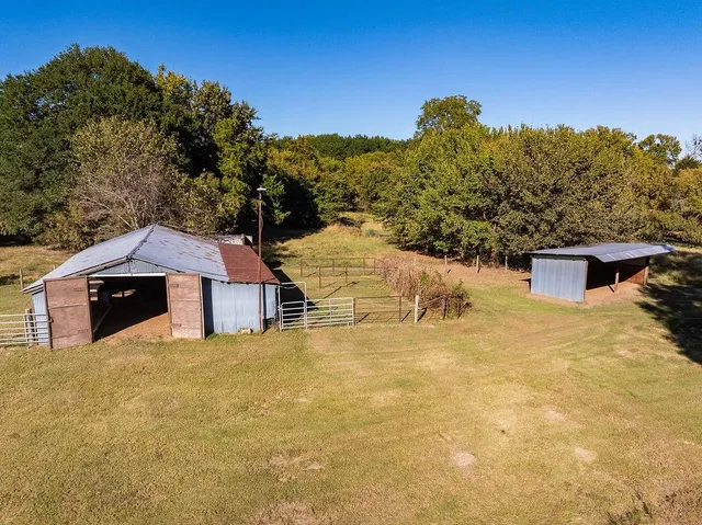 a view of a house with a yard and mountain view