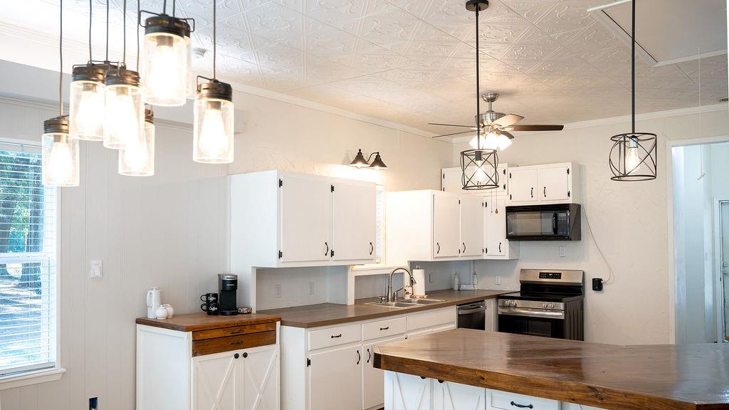 213 County Road 2320 Telephone, TX 75488 - Photo 6 of 40 a kitchen with stainless steel appliances granite countertop a sink and a stove