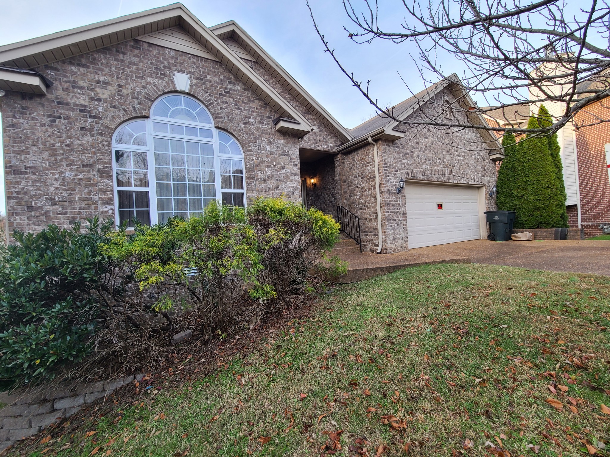 728 Canoe Ridge Point Antioch, TN 37013 - Photo 3 of 40 a view of a brick house with a yard and large tree
