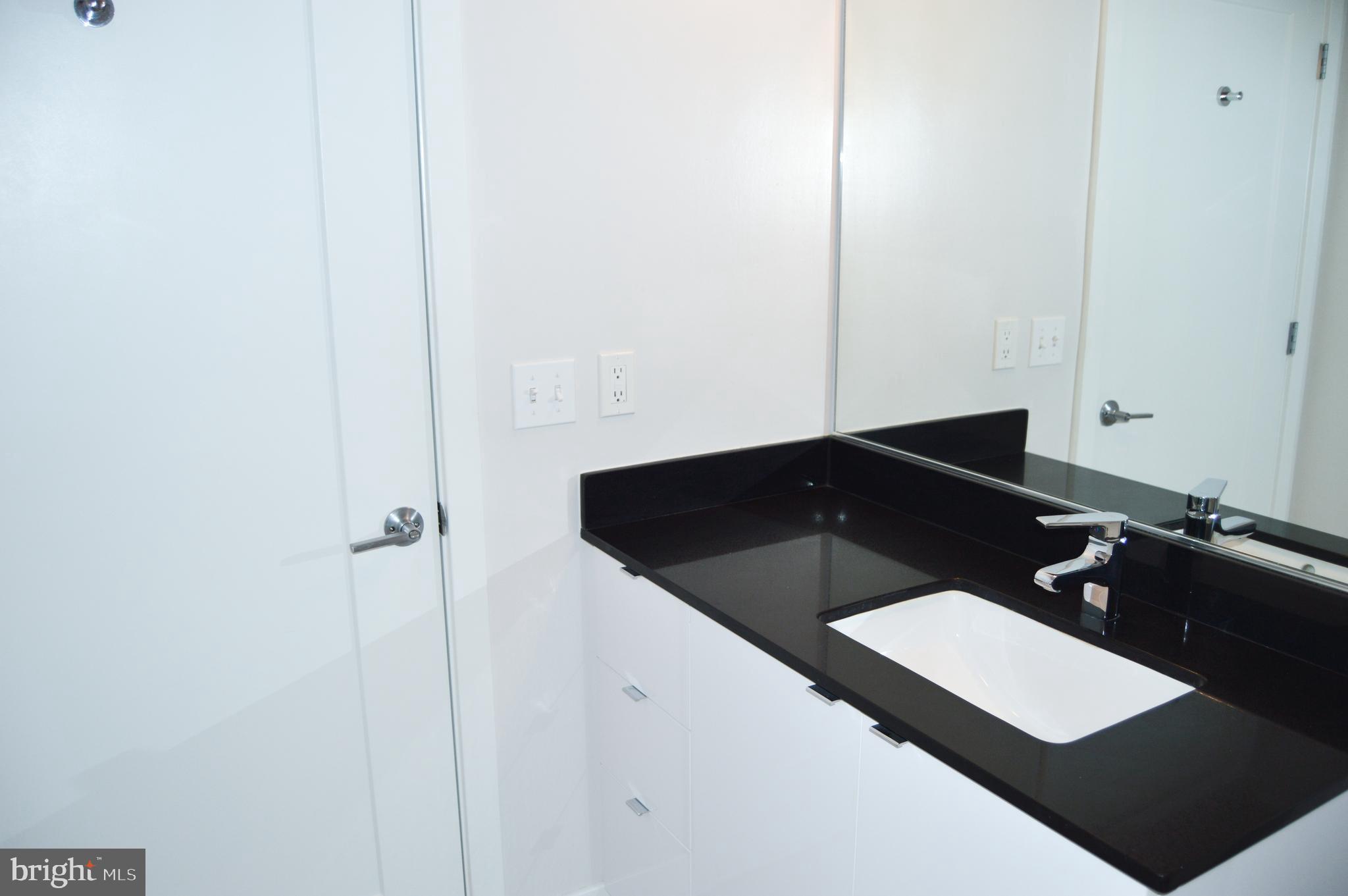 460 New York Avenue Northwest, Unit 805 Washington, DC 20001 - Photo 11 of 21 a bathroom with a sink and a mirror