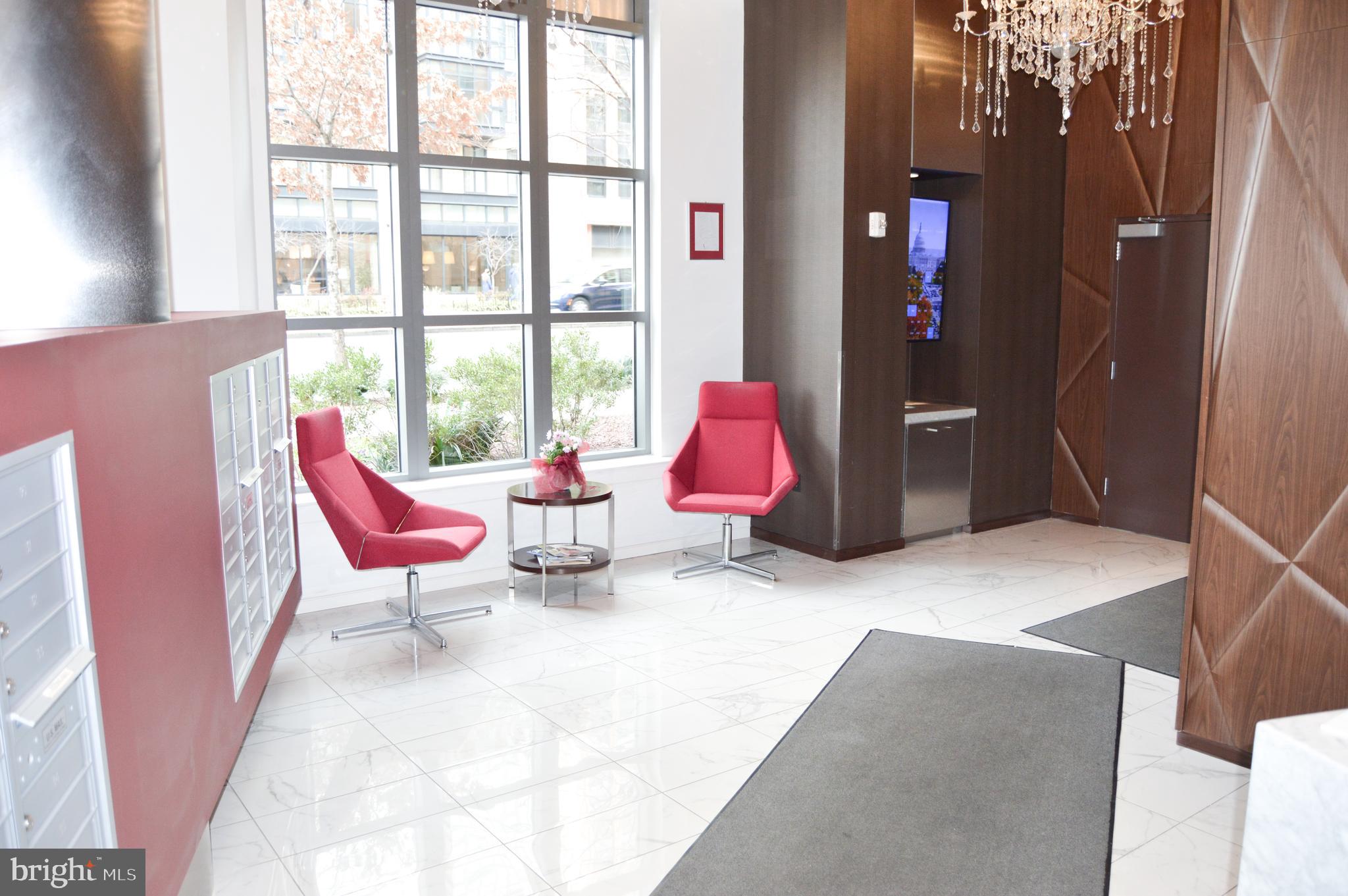 460 New York Avenue Northwest, Unit 805 Washington, DC 20001 - Photo 15 of 21 a living room with furniture a rug and a large window