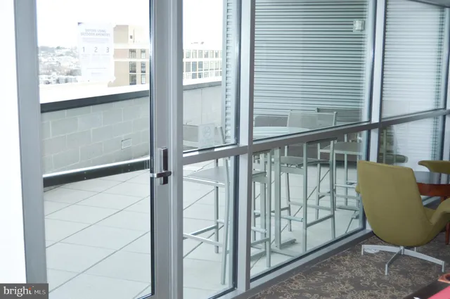 a view of a balcony with chairs and wooden floor