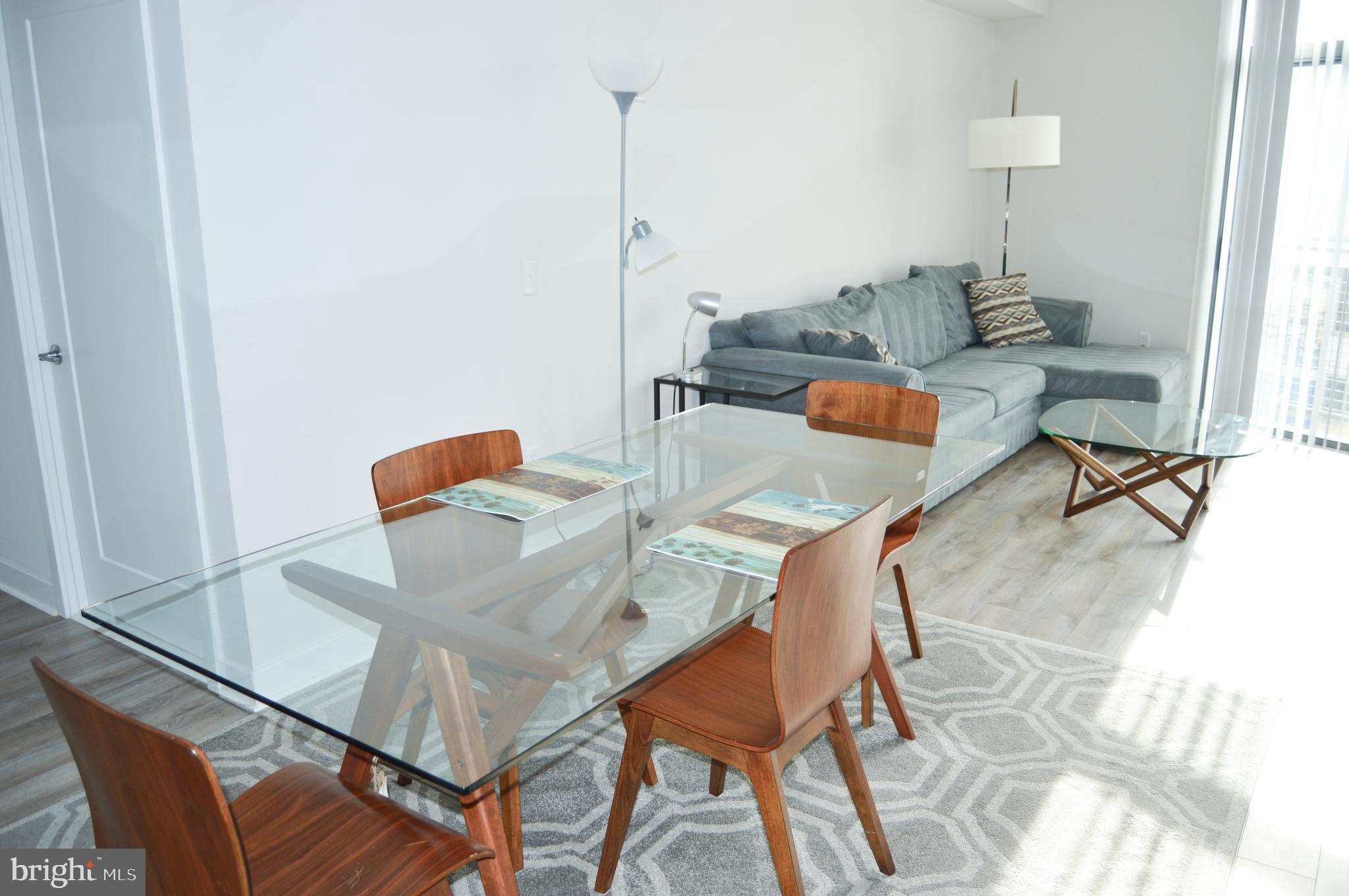 460 New York Avenue Northwest, Unit 805 Washington, DC 20001 - Photo 4 of 21 a living room with furniture and a wooden floor