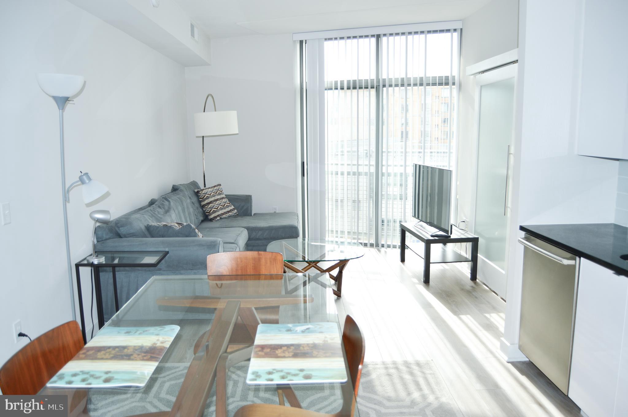 460 New York Avenue Northwest, Unit 805 Washington, DC 20001 - Photo 8 of 21 a living room with furniture and a table