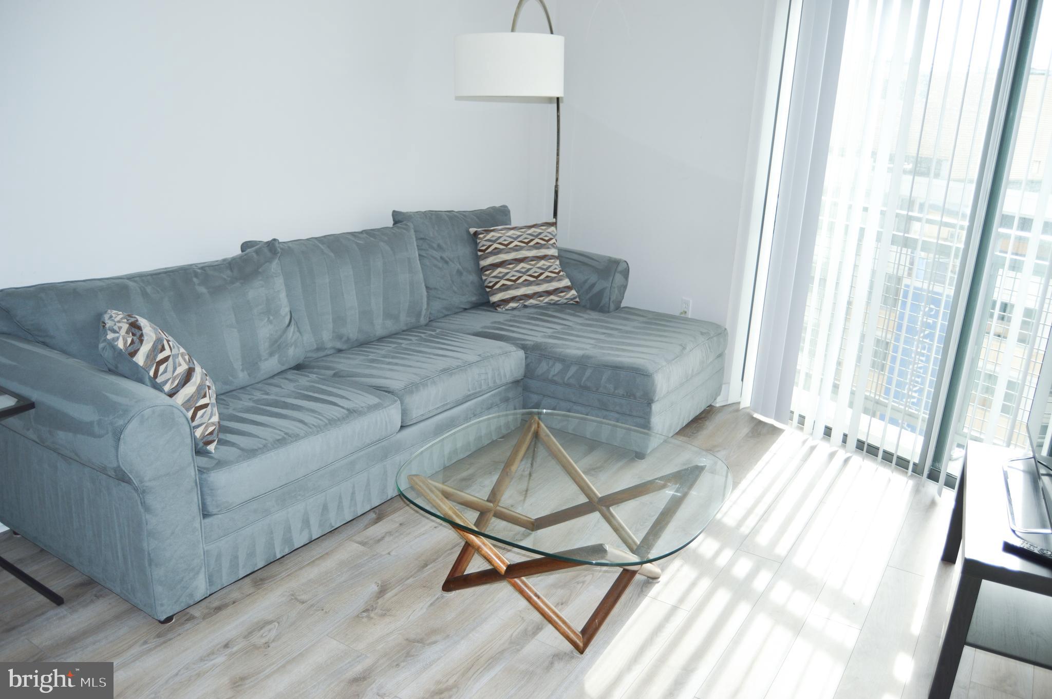 460 New York Avenue Northwest, Unit 805 Washington, DC 20001 - Photo 9 of 21 a living room with a couch and a table
