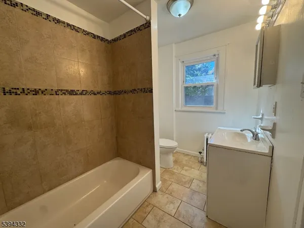 a bathroom with a tub a sink and a shower