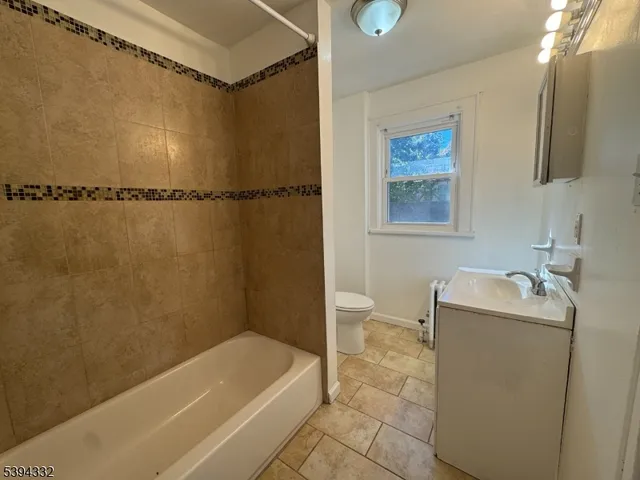 a bathroom with a tub a sink and a shower