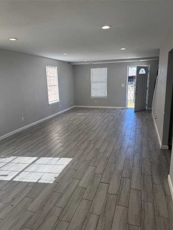 8502 North Main Street Houston, TX 77022 - Photo 3 of 13 a view of an empty room with wooden floor and window