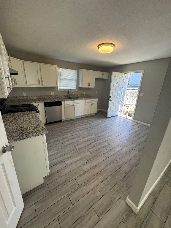 8502 North Main Street Houston, TX 77022 - Photo 5 of 13 a kitchen with stainless steel appliances granite countertop a sink and a stove