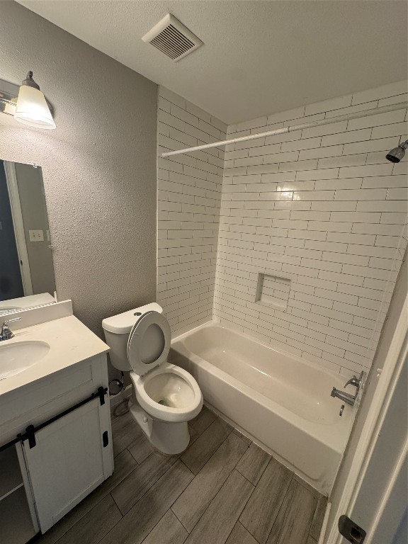 8502 North Main Street Houston, TX 77022 - Photo 10 of 13 a bathroom with a granite countertop toilet a sink and bathtub