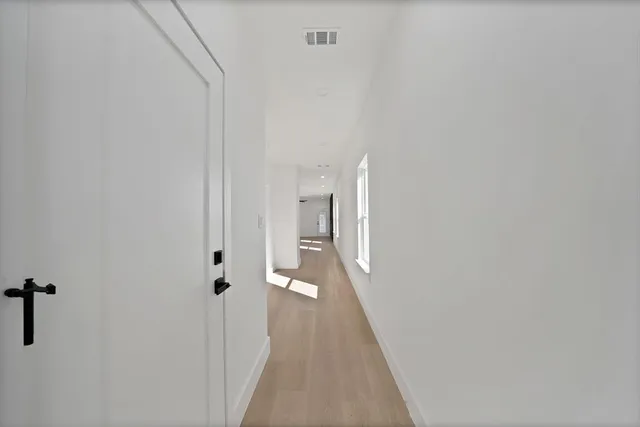 a view of a hallway with a white walls