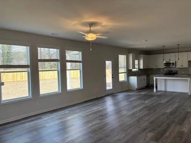 wooden floor fireplace and windows in an empty room