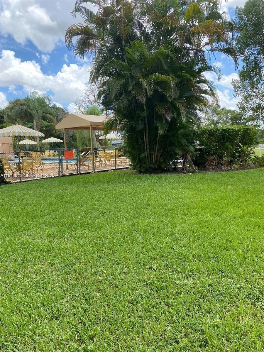 8838 West McNab Road, Unit 104 Tamarac, FL 33321 - Photo 21 of 23 a view of a house with a garden