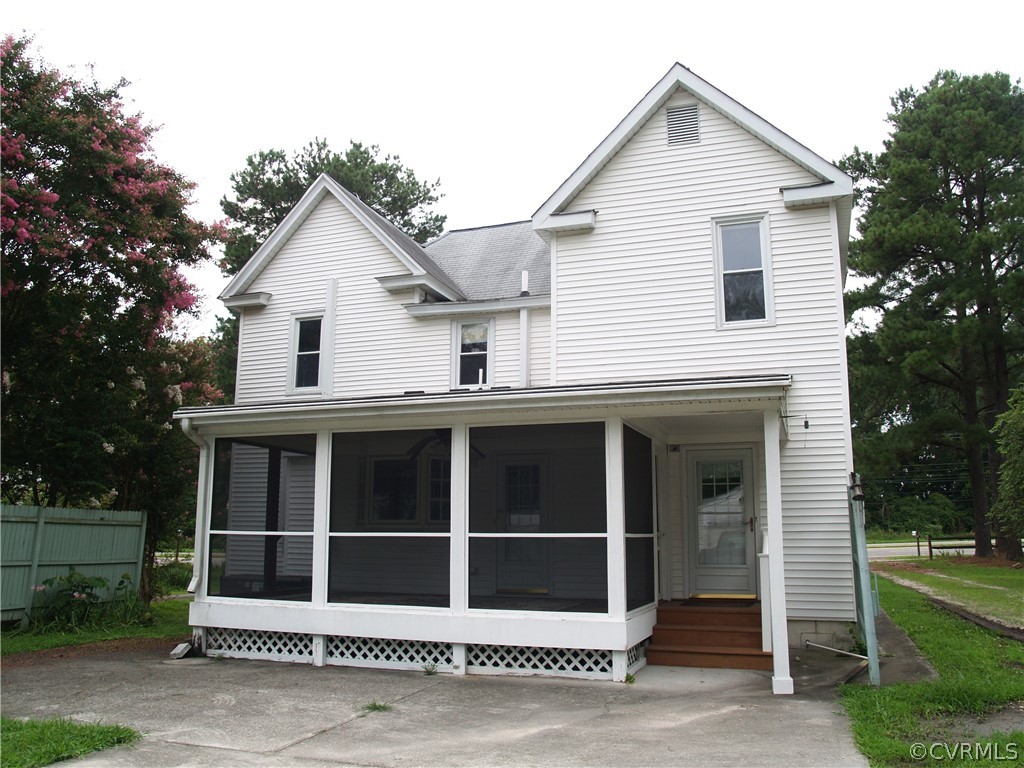 Screened porch compliments rear of home.