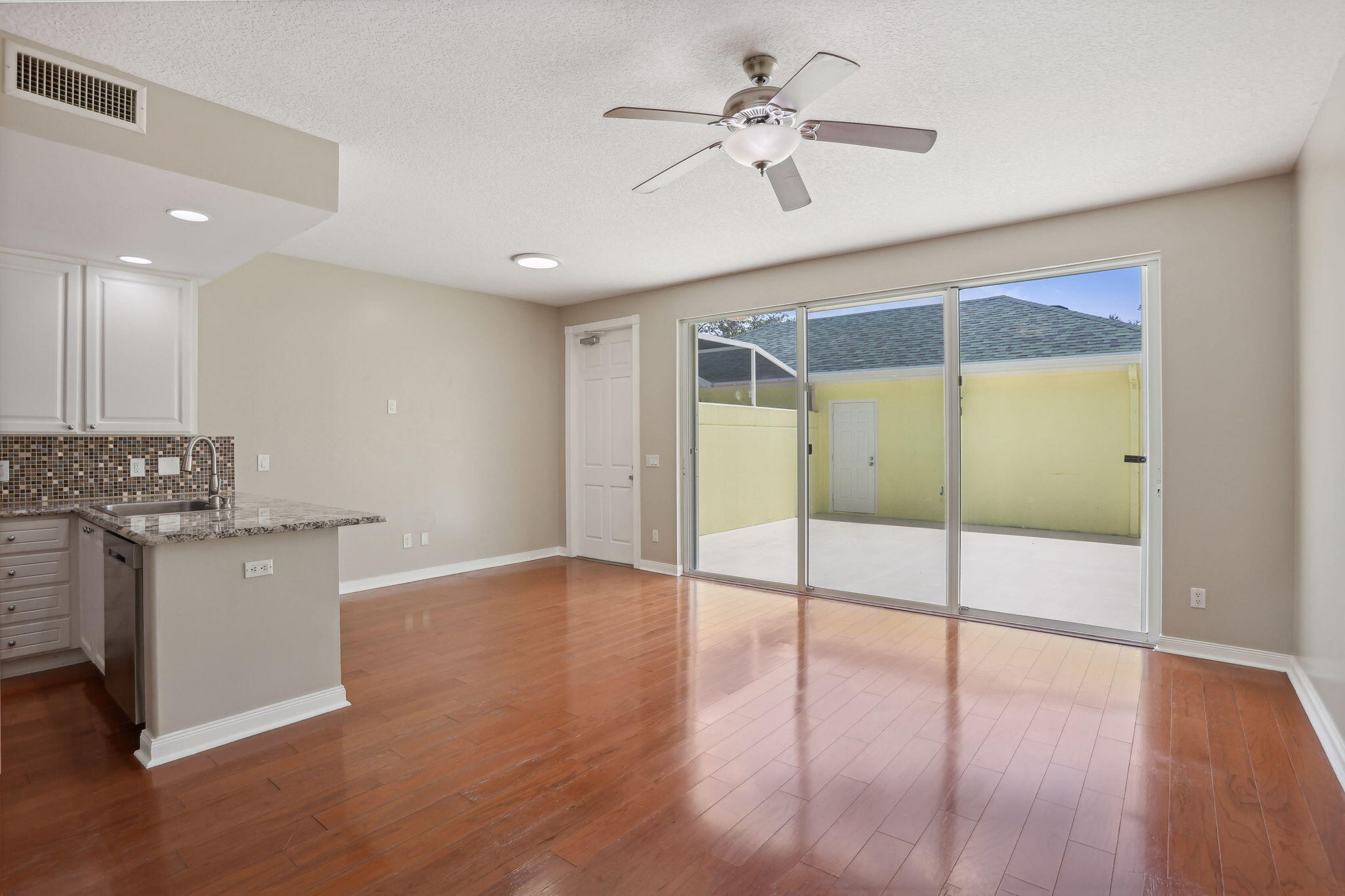 155 Waterford Drive Jupiter, FL 33458 - Photo 14 of 51 a view of an empty room with window and wooden floor