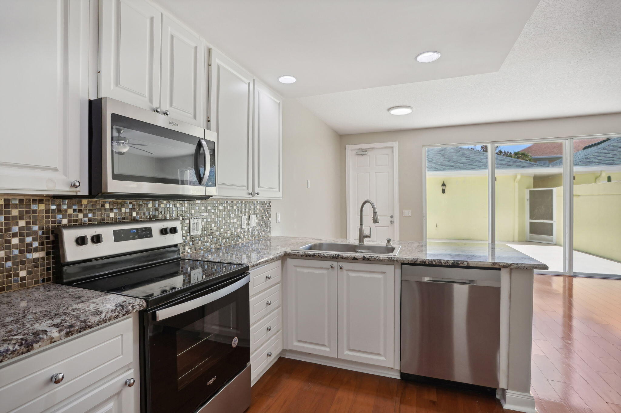 155 Waterford Drive Jupiter, FL 33458 - Photo 17 of 51 a kitchen with granite countertop a stove sink and cabinets