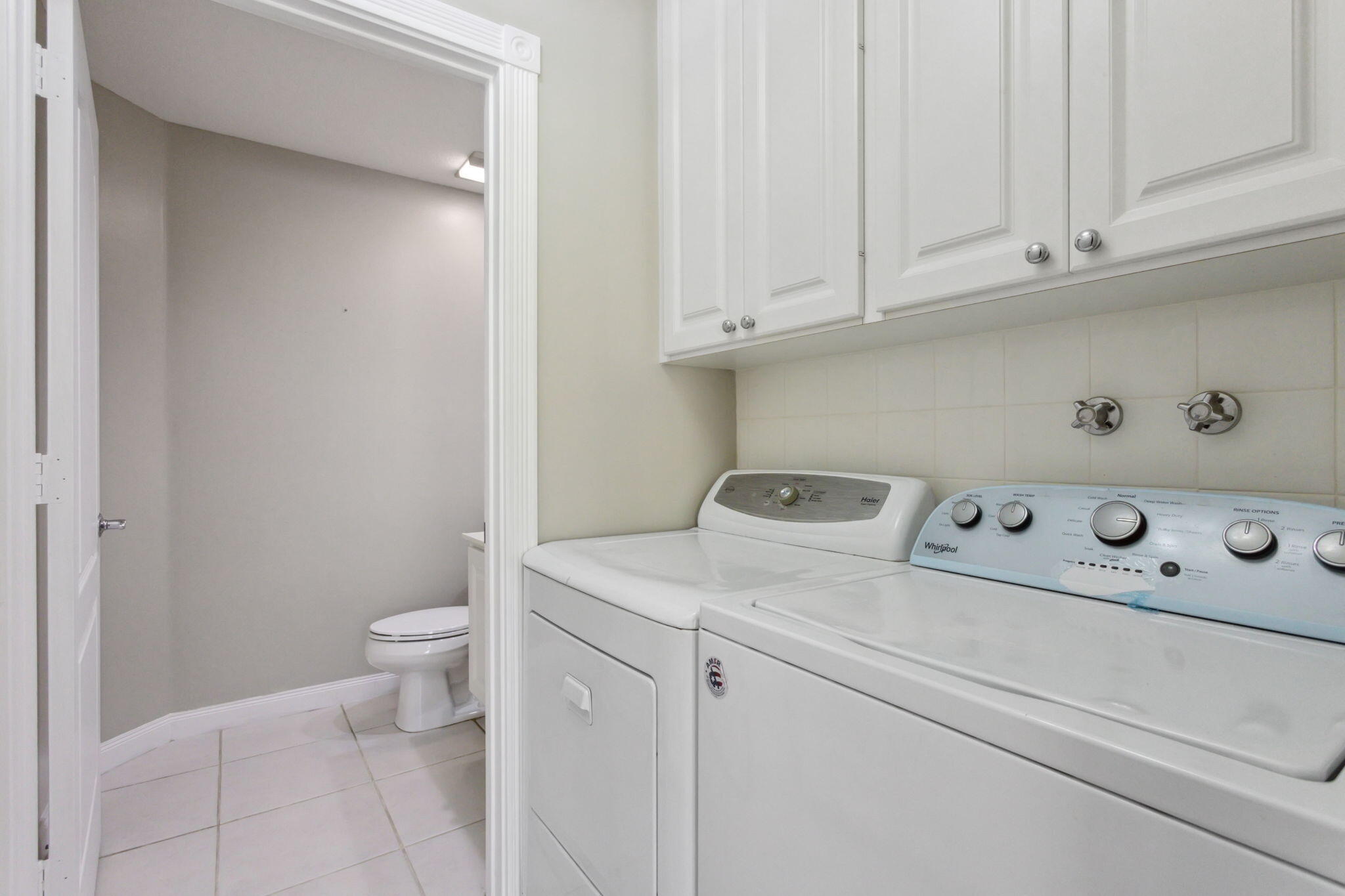 155 Waterford Drive Jupiter, FL 33458 - Photo 18 of 51 a utility room with dryer and washer
