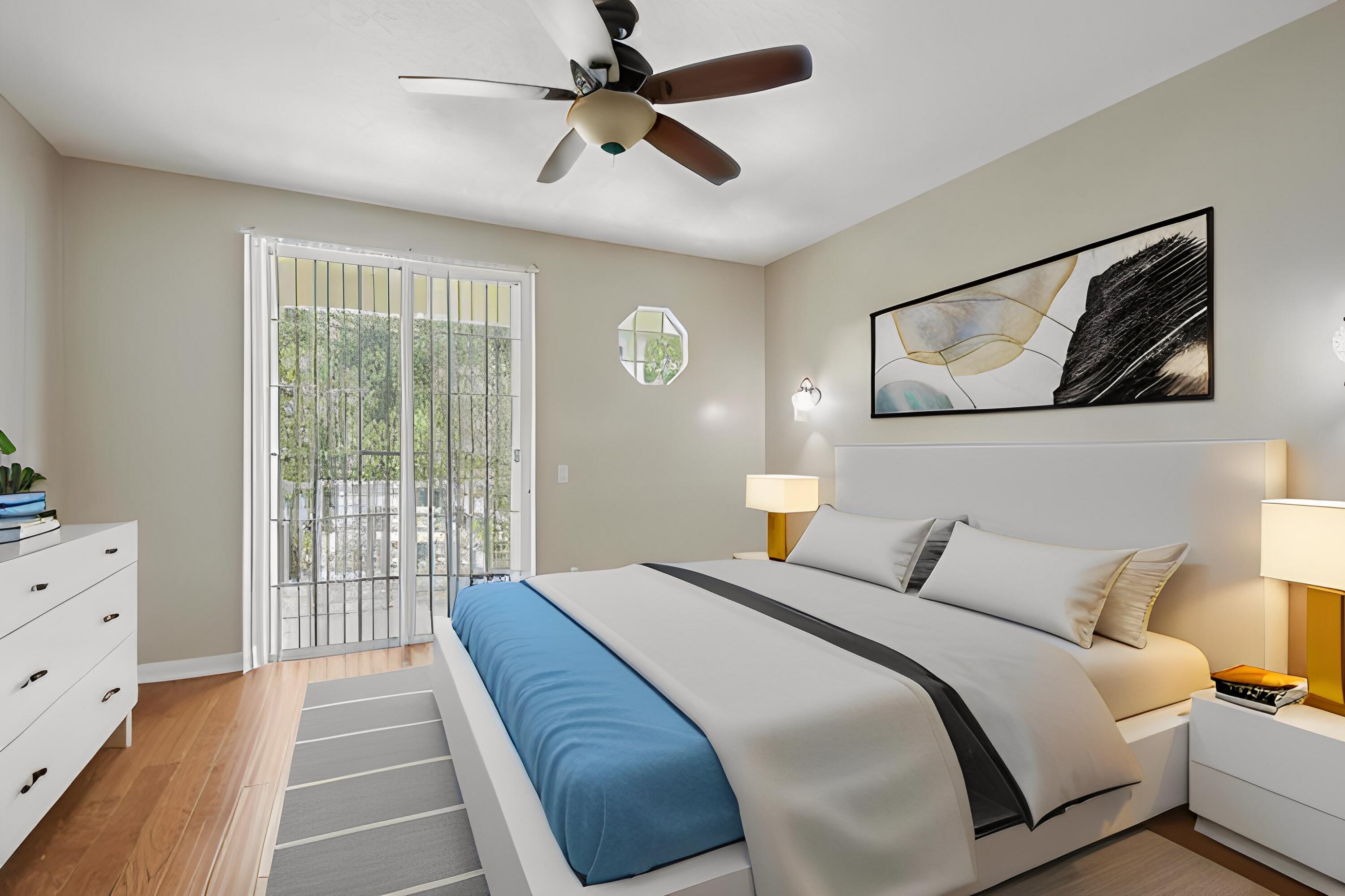 155 Waterford Drive Jupiter, FL 33458 - Photo 22 of 51 a bedroom with a bed and a window