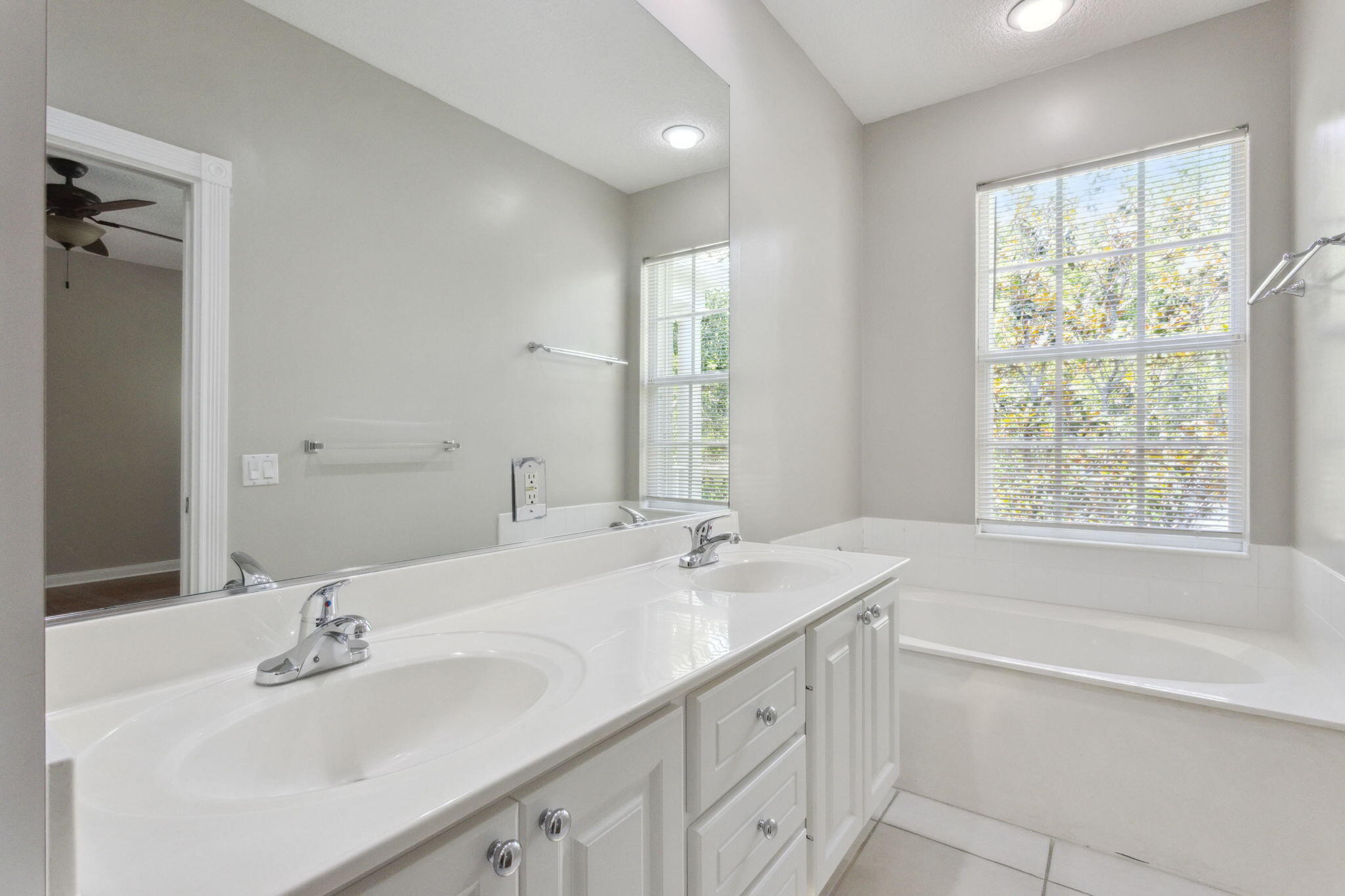 155 Waterford Drive Jupiter, FL 33458 - Photo 26 of 51 a bathroom with a sink double vanity mirror and a bathtub