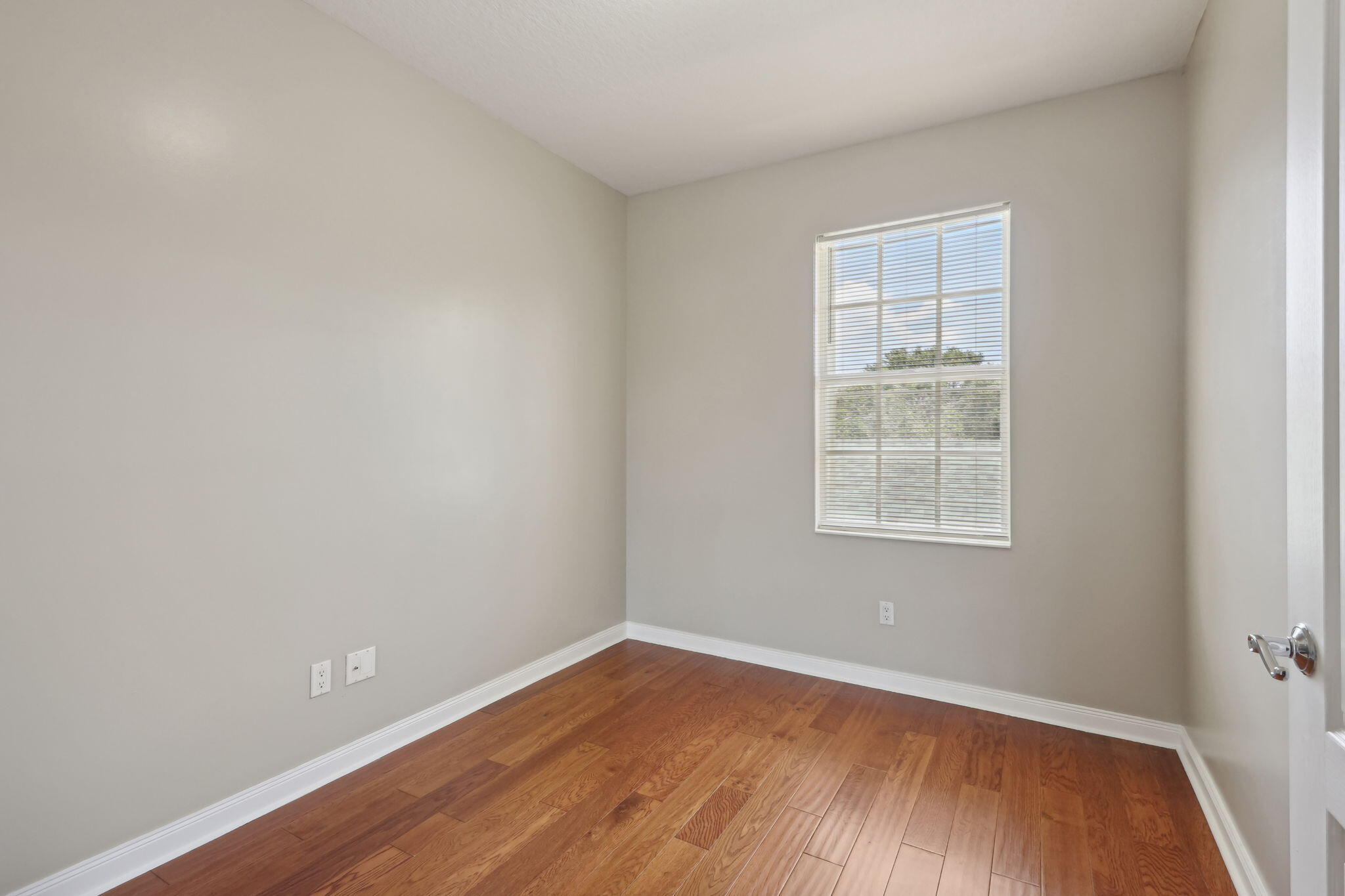 155 Waterford Drive Jupiter, FL 33458 - Photo 32 of 51 an empty room with wooden floor and windows