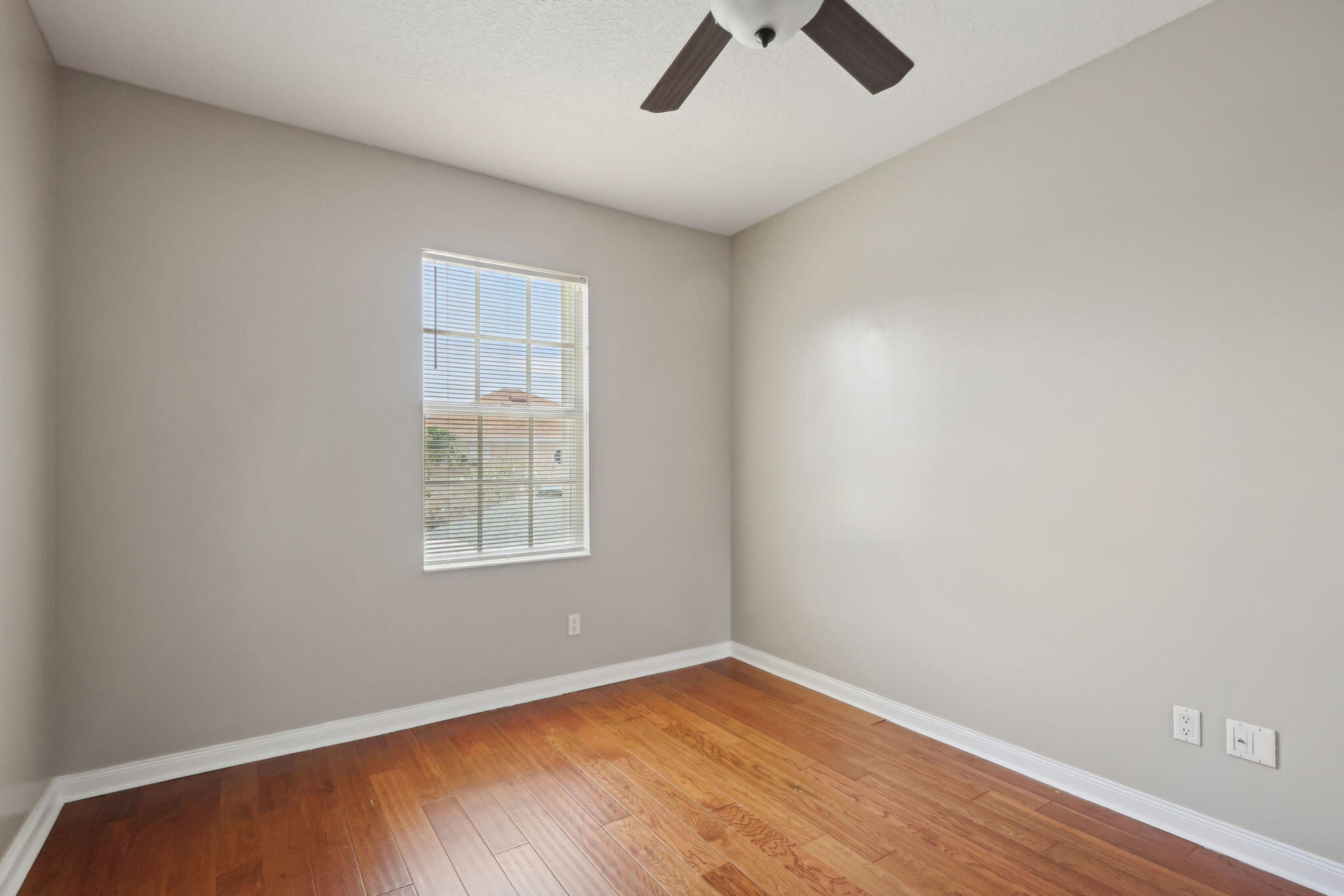 155 Waterford Drive Jupiter, FL 33458 - Photo 34 of 51 an empty room with a window and ceiling fan