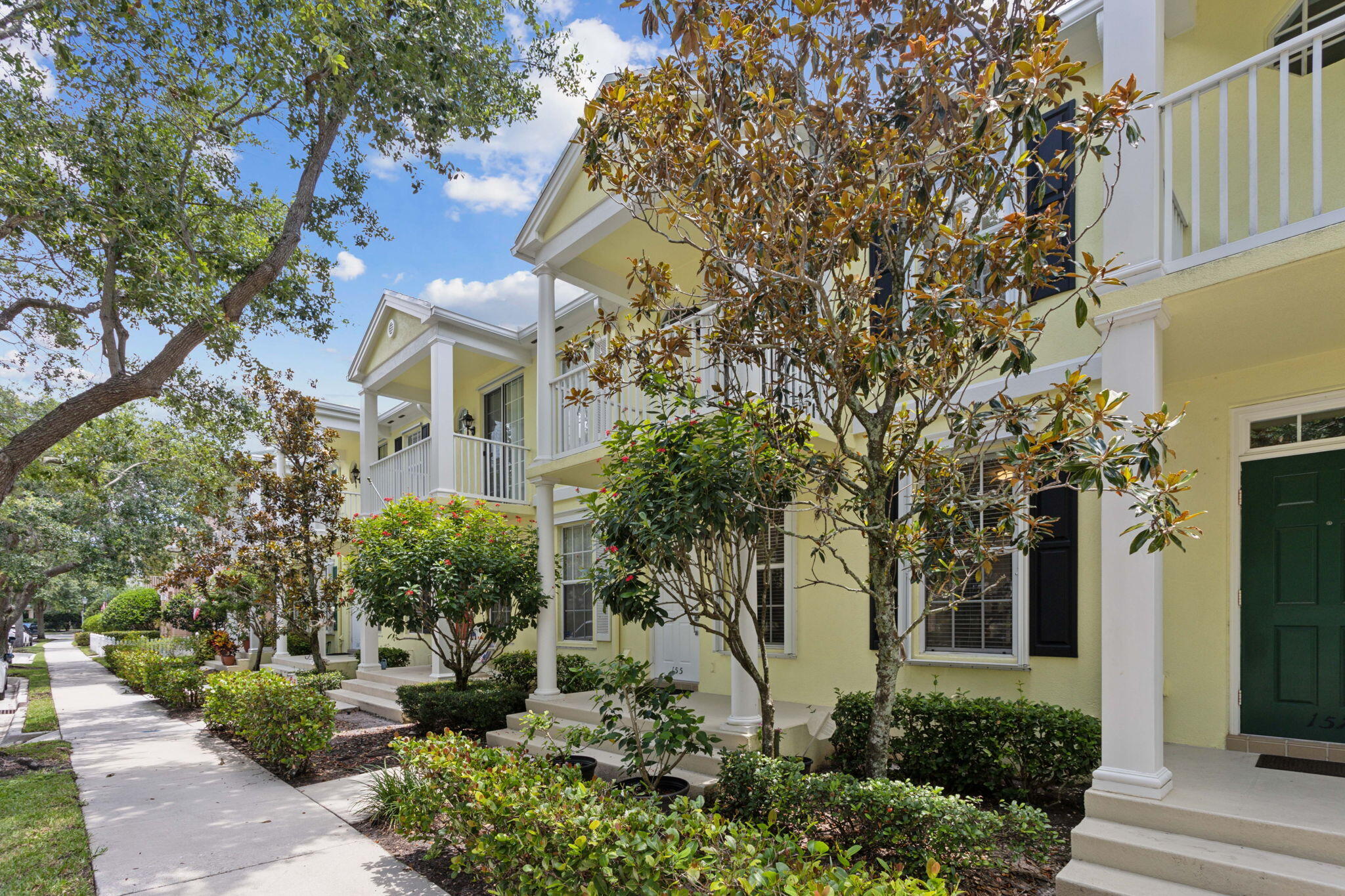 155 Waterford Drive Jupiter, FL 33458 - Photo 4 of 51 a front view of a house with a garden