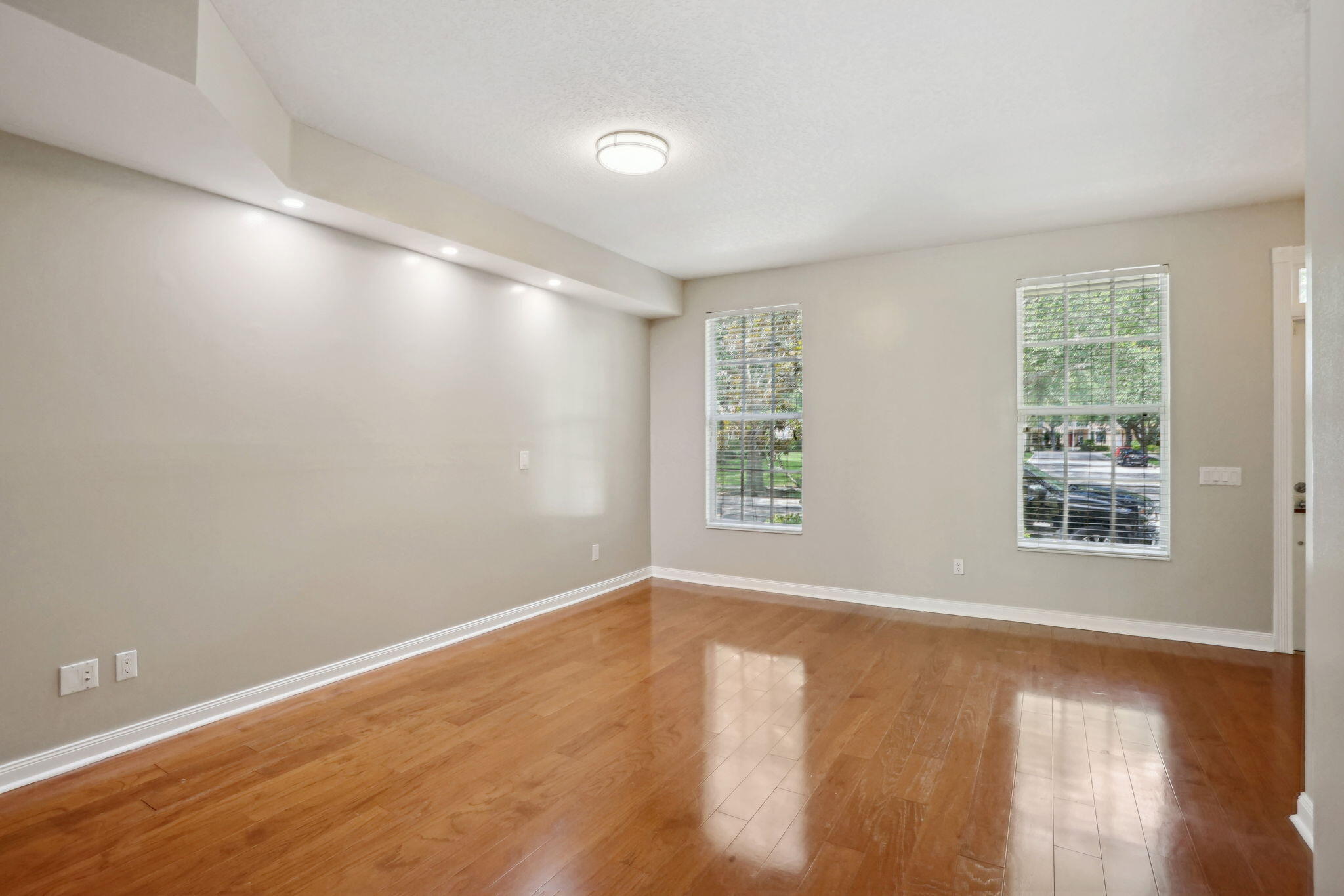 155 Waterford Drive Jupiter, FL 33458 - Photo 8 of 51 an empty room with wooden floor and windows