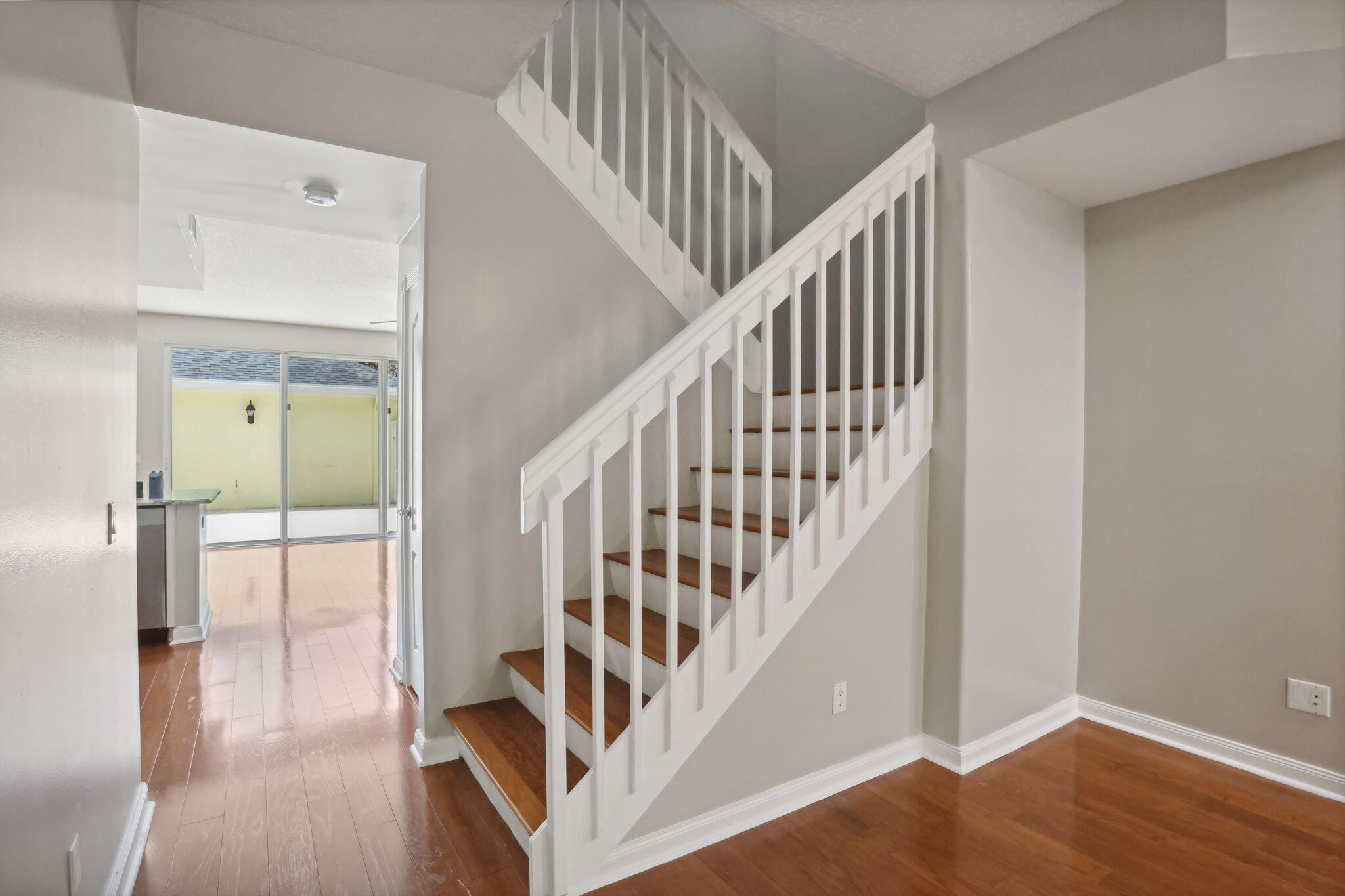 155 Waterford Drive Jupiter, FL 33458 - Photo 10 of 51 a view of staircase with wooden floor and white walls
